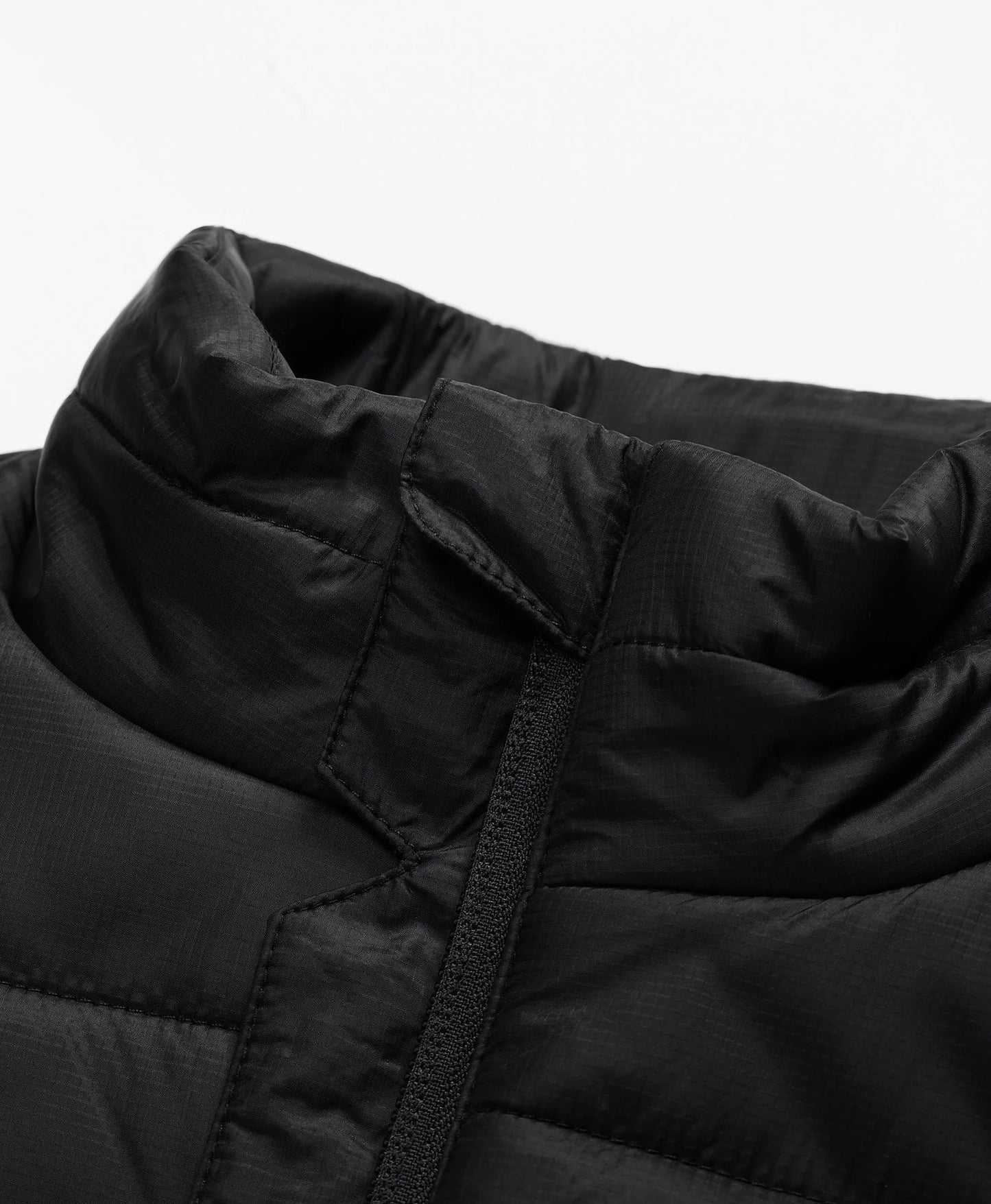 Full-zip vest with a zip-through, stand-up collar for added versatility and warmth.